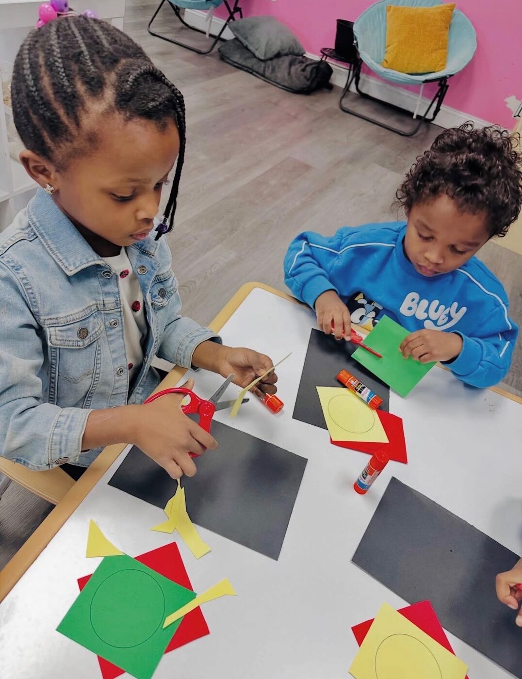 Children concentrating in a cozy home-like classroom in Raleigh NC